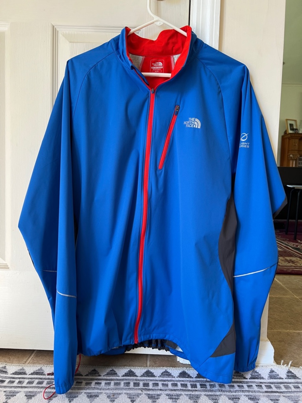 The North Face Men's Blue Windbreaker with Red Accents